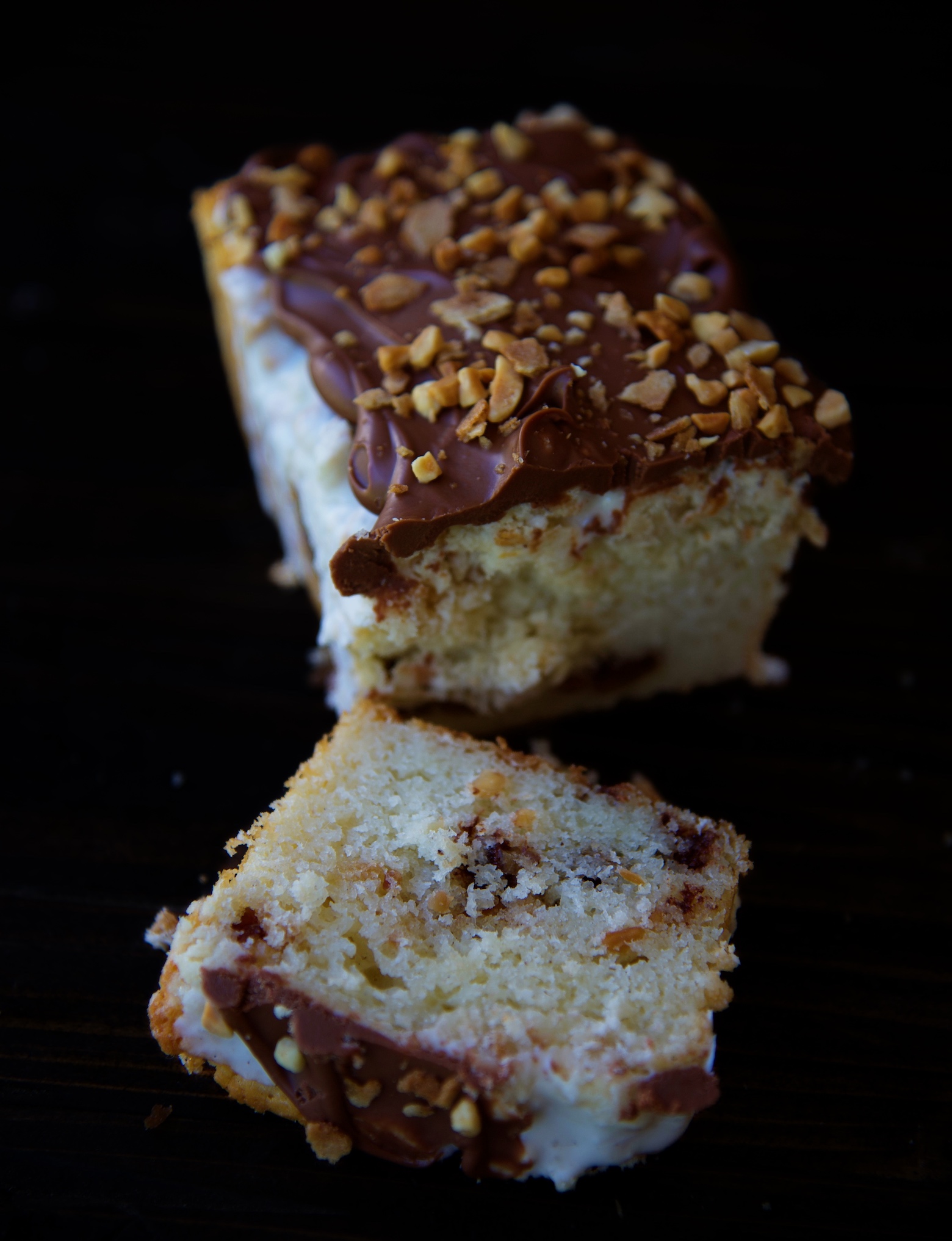 Single crumb cake with a slice of cake cut off and laying down. Exposing the inside of the crumb cake. 