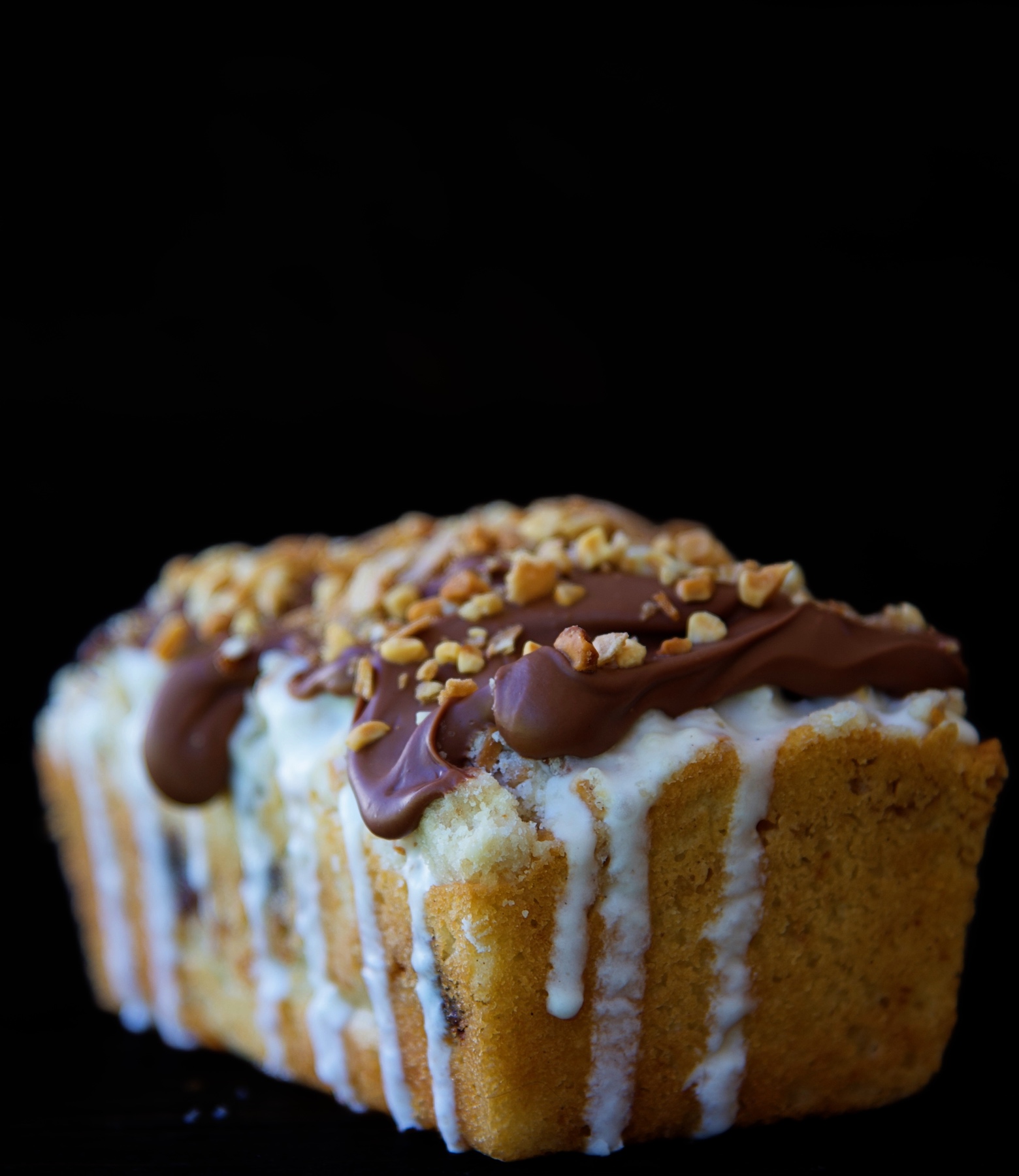 SIde shot of a Glazed Drumstick Crumb Cake showing the vanilla ice cream glaze dripping down. 