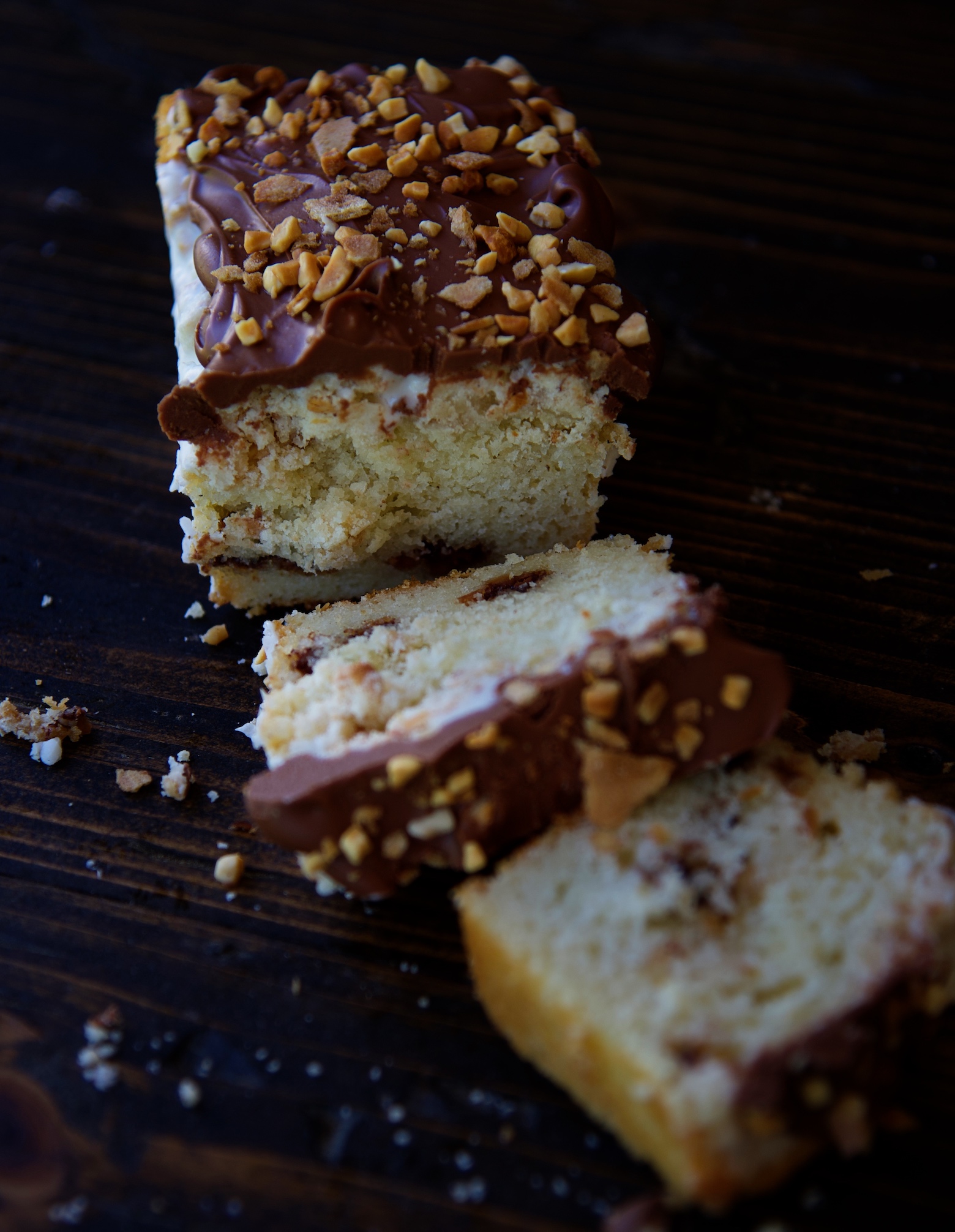 Single crumb cake with two pieces cut off and laying down. Exposing the inside of the crumb cake. 