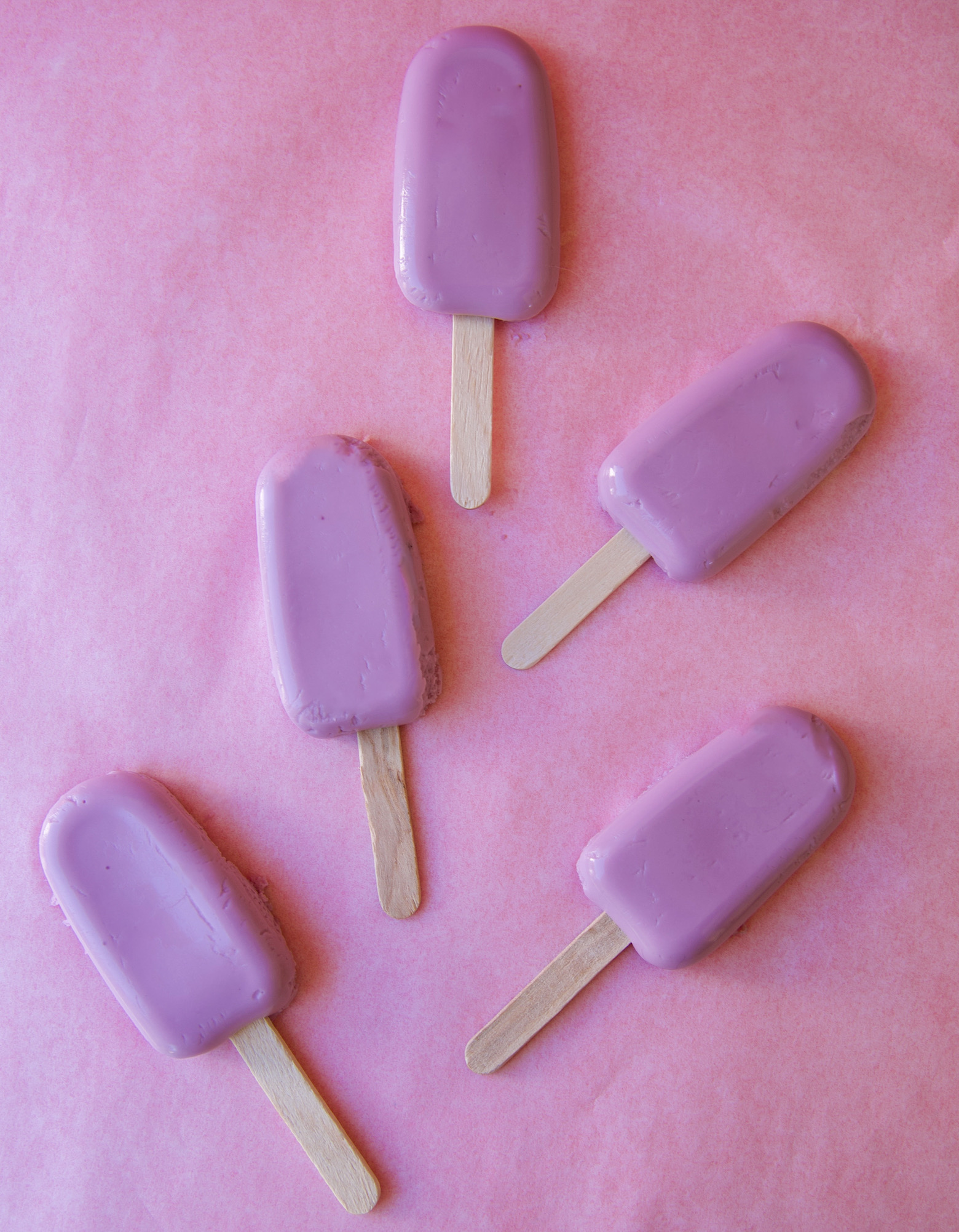 Overhead shot of Grape Popsicle Jello Molds in mini popsicle mold shape with popsicle sticks coming out of them. 