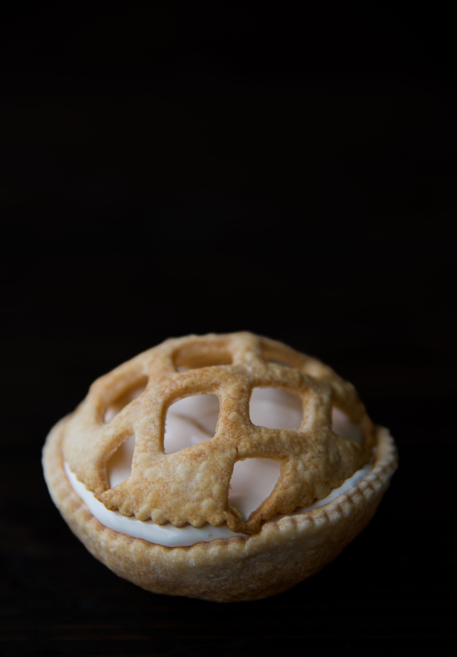 Single Apple Pie Pudding Shot in pie crust shell with a pie crust lattice dome on top. 