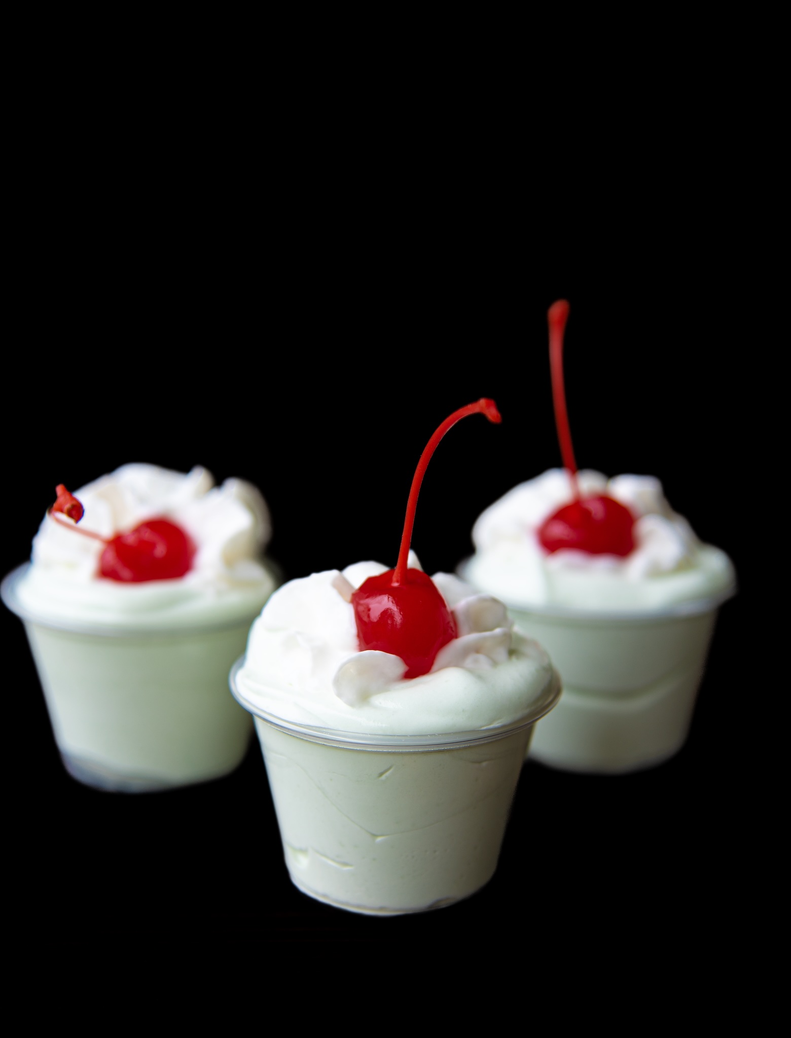 Three Shamrock Shake Pudding Shots with the focus on the middle shot. 