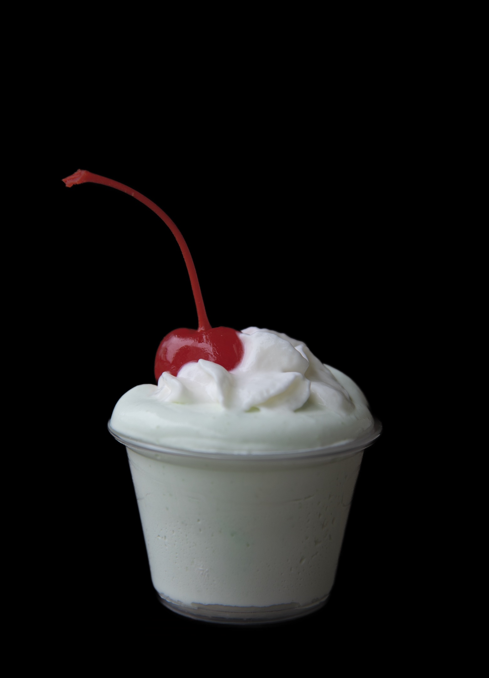 Single Shamrock Shake Pudding Shot with a focus on the cherry