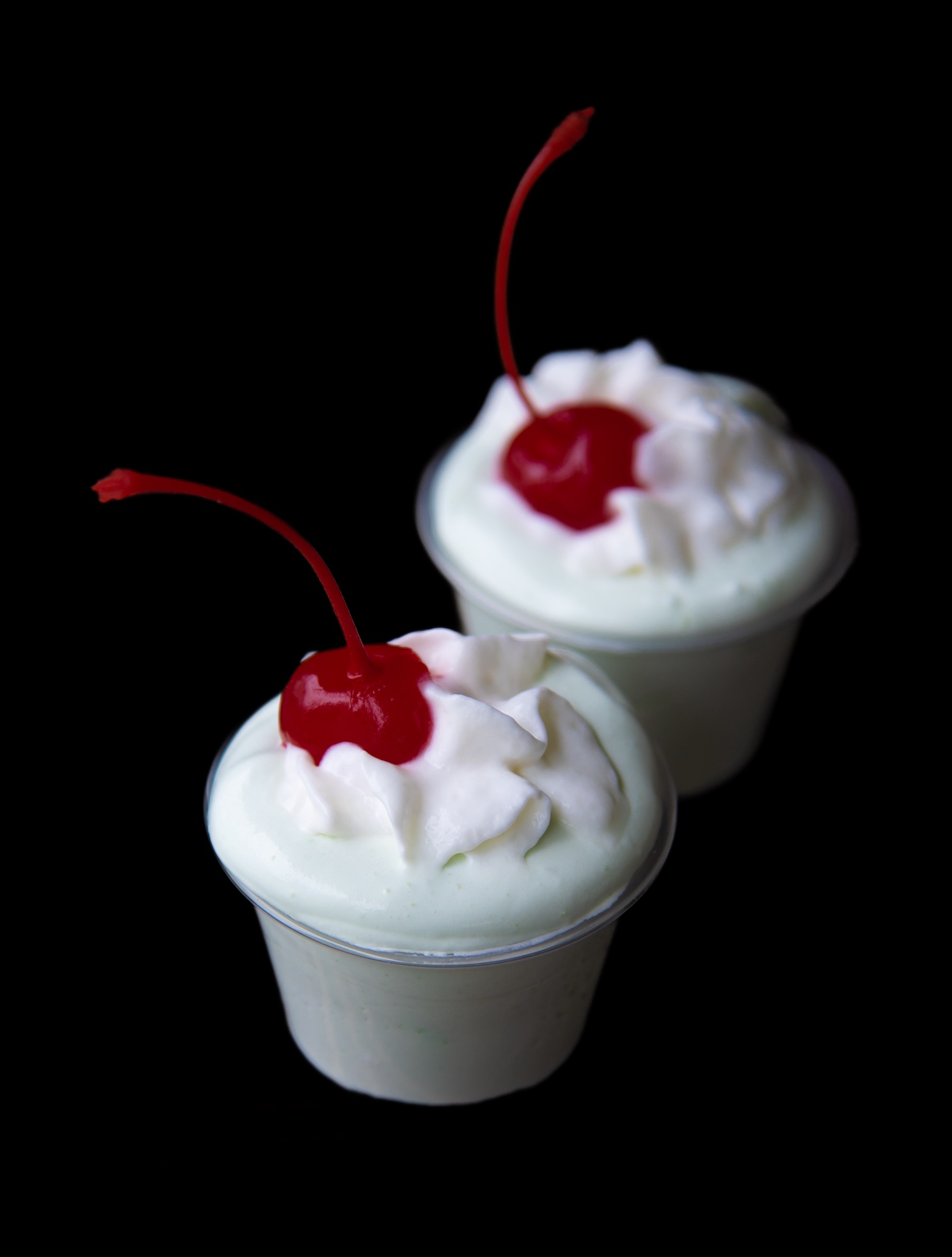 Two Shamrock Shake Pudding Shots with the focus being on the first shot.